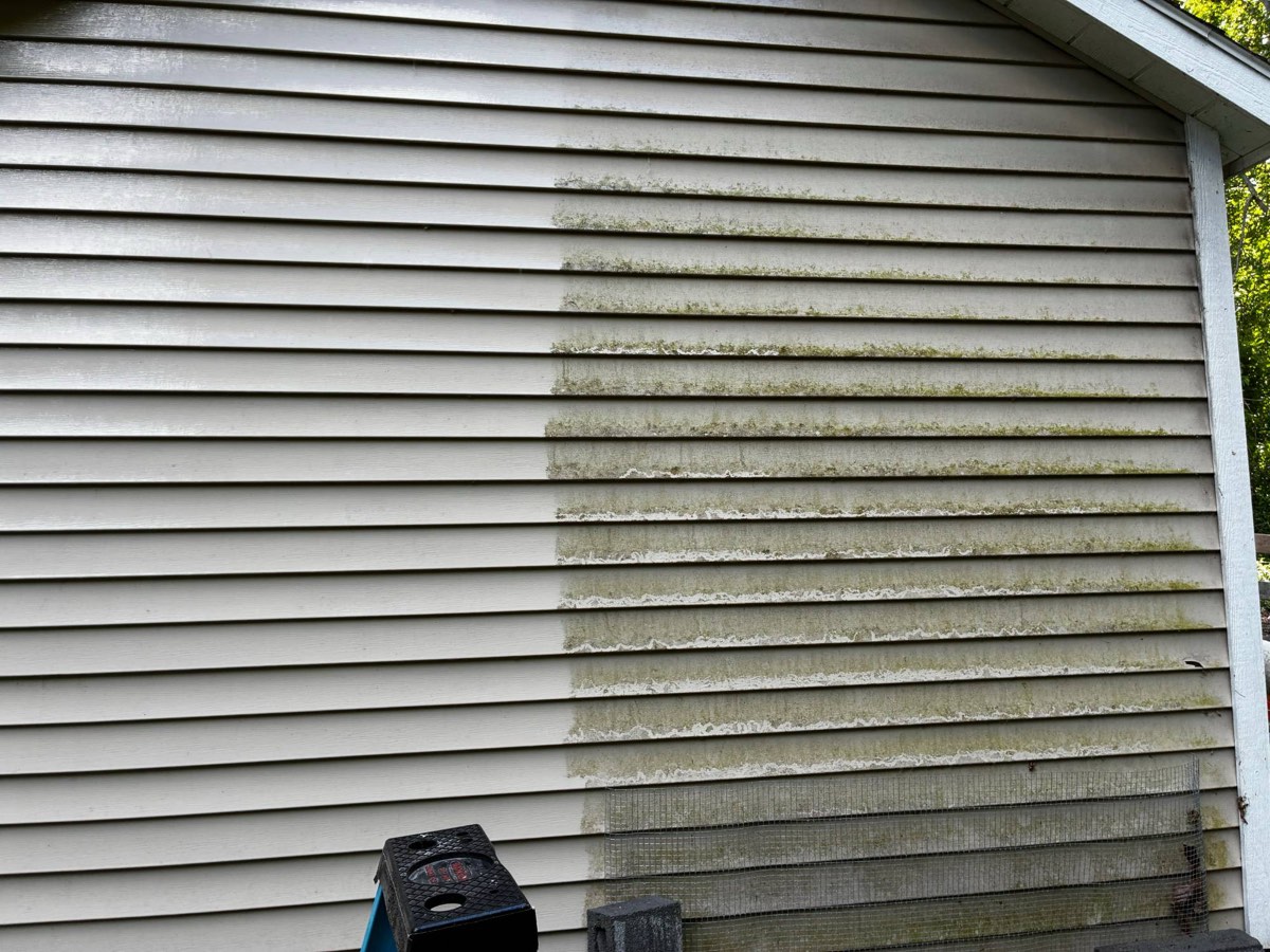 Vinyl siding half cleaned, showing the dramatic difference of a single pass